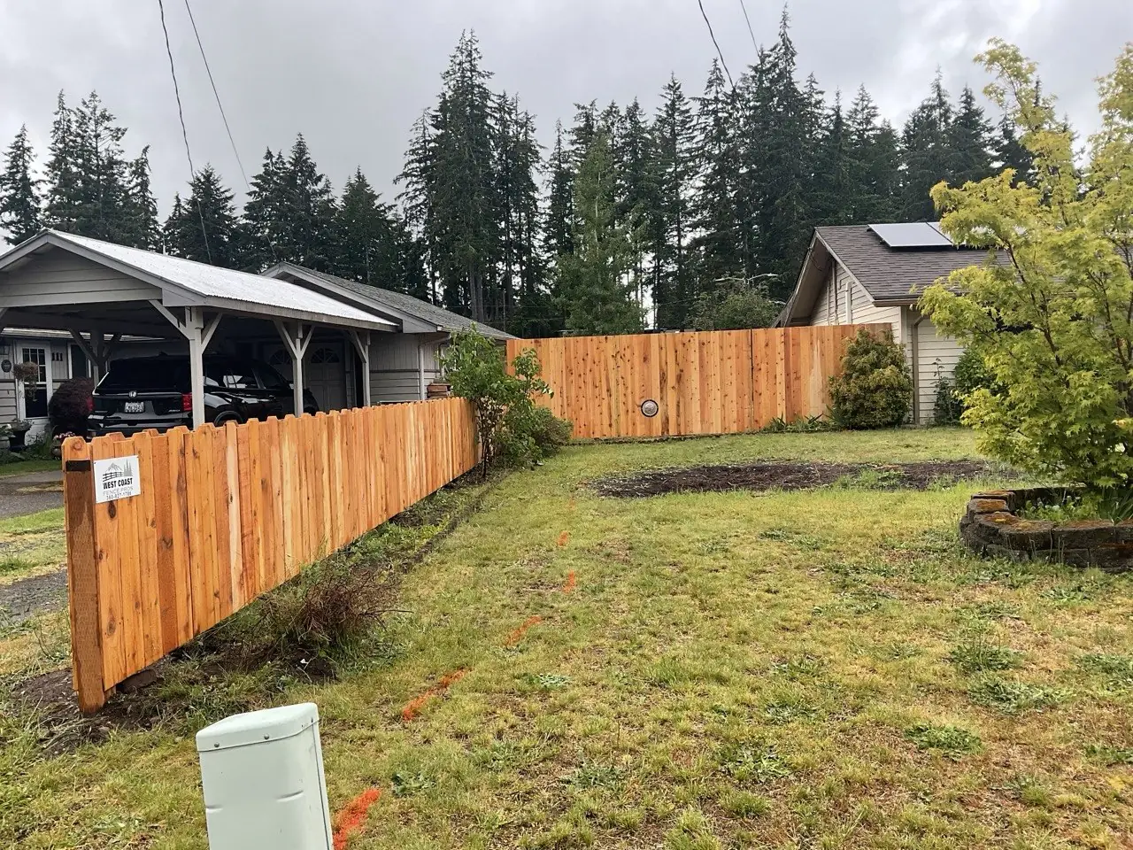 Cedar dog-ear privacy fence installed in a residential front yard in Western Washington